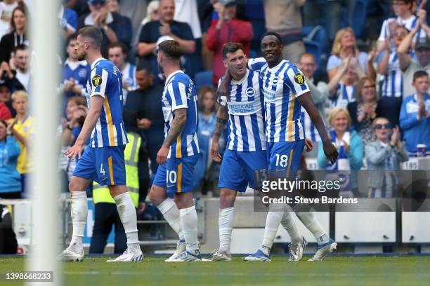 Pascal Gross of Brighton & Hove Albion celebrates with teammate Danny Welbeck after scoring their side's second goal during the Premier League match...