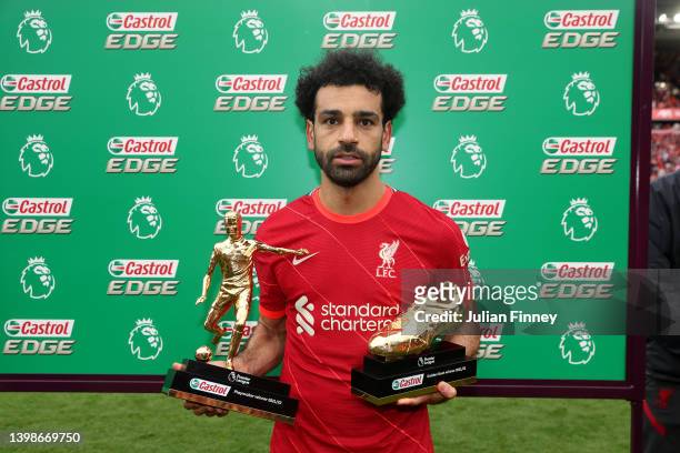 Mohamed Salah of Liverpool poses with the Castrol Playmaker Winner 2021/22 award and the Castrol Golden Boot award after the Premier League match...