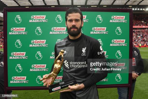 Alisson Becker of Liverpool poses with the Castrol Golden Glove Winner award after the Premier League match between Liverpool and Wolverhampton...