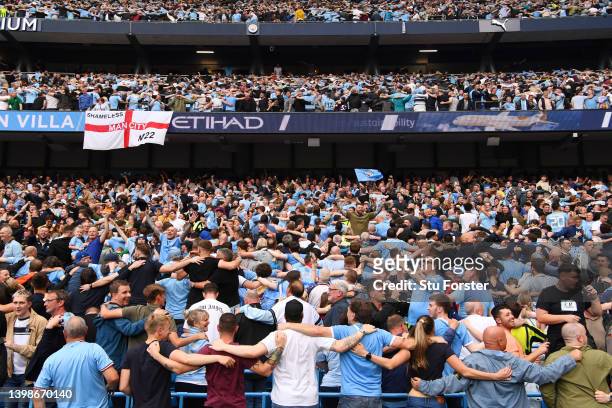 Manchester City fans do a Poznan celebration after their side finished the season as Premier League champions during the Premier League match between...