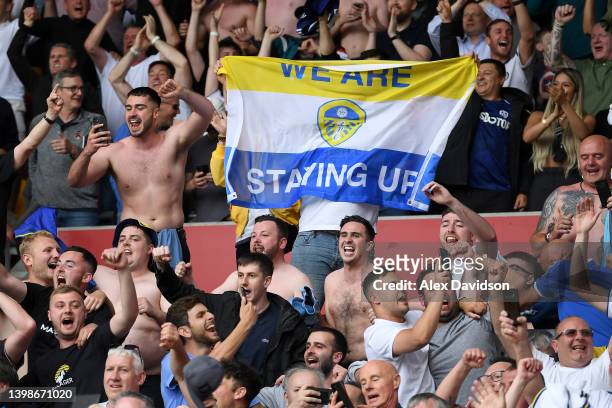 Leeds United fans celebrate avoiding relegation and their side's victory in the Premier League match between Brentford and Leeds United at Brentford...