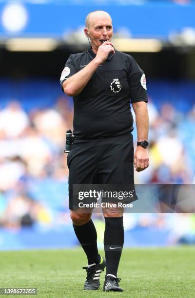 Referee, Mike Dean reacts during the Premier League match between Chelsea and Watford at Stamford Bridge on May 22, 2022 in London, England.