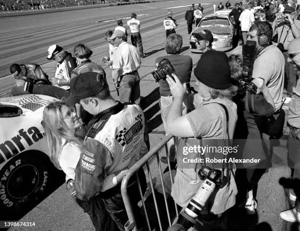 Driver Eric McClure hugs his wife, Miranda, as a photographer takes their photograph prior to McClure attempting and failing to qualify for the 2005...