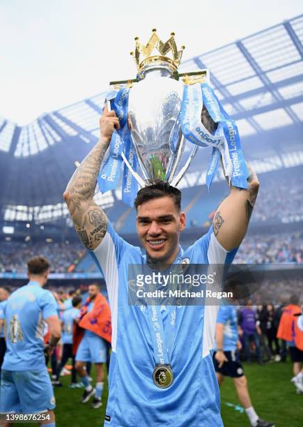 Ederson of Manchester City lifts the Premier League trophy after their side finished the season as Premier League champions during the Premier League...