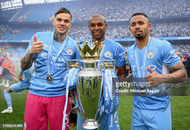 Ederson, Fernandinho and Gabriel Jesus of Manchester City pose with the Premier League trophy after their side finished the season as Premier League...