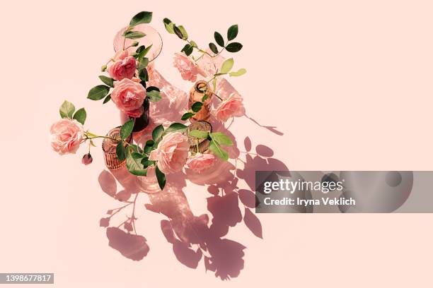 summer scene with pink rose flowers in the vases. sun and shadows. minimal nature background. - yellow rose stock pictures, royalty-free photos & images