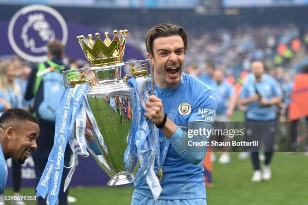 Jack Grealish of Manchester City celebrates with the Premier League trophy after their side finished the season as Premier League champions during...