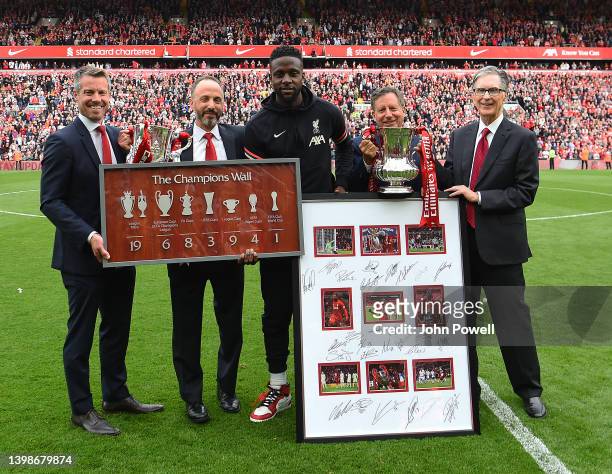 Divock Origi of Liverpool receives gifts from Billy Hogan CEO of Liverpool Football Club Fenway Sports Group president Mike Gordon, Fenway Sports...