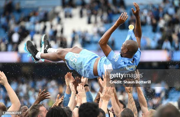 Fernandinho of Manchester City is lifted in the air by teammates after their last game for Manchester City as their side finished the season as...