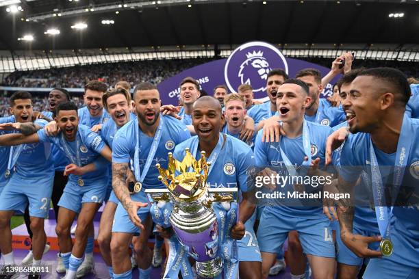 Fernandinho of Manchester City lifts the Premier League trophy after their side finished the season as Premier League champions during the Premier...