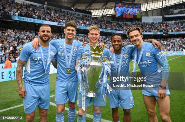 Kyle Walker, John Stones, Kevin De Bruyne, Raheem Sterling and Jack Grealish of Manchester City pose with the Premier League trophy after their side...