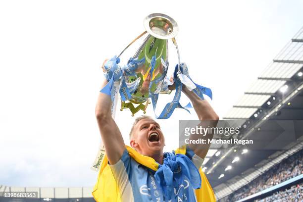Oleksandr Zinchenko of Manchester City celebrates with the Premier League trophy and a Ukrainian flag after their side finished the season as Premier...