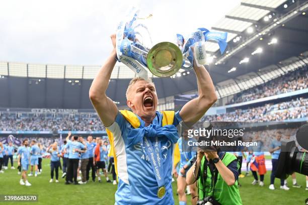 Oleksandr Zinchenko of Manchester City celebrates with the Premier League trophy and a Ukrainian flag after their side finished the season as Premier...