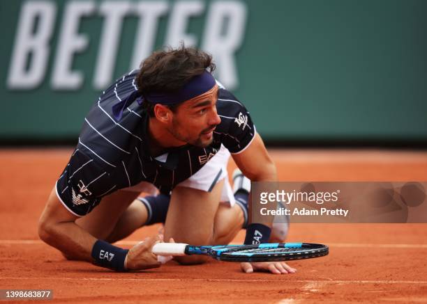 Fabio Fognini of Italy reacts after falling over during his mens singles first round match against Alexei Popyrin of Australia on day 1 of the 2022...
