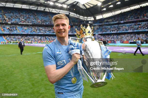 Kevin De Bruyne of Manchester City celebrates with the Premier League trophy after their side finished the season as Premier League champions during...