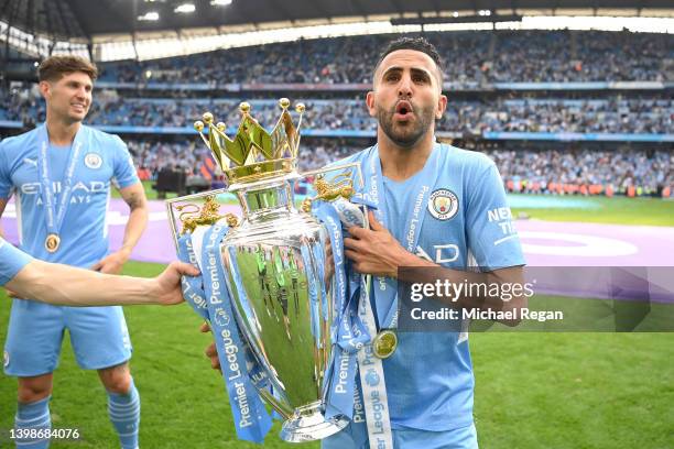 Riyad Mahrez of Manchester City celebrates with the Premier League trophy after their side finished the season as Premier League champions during the...