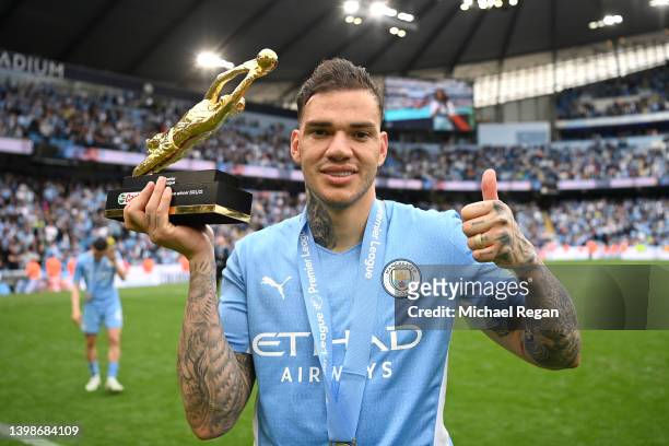 Ederson of Manchester City celebrates with the Castrol Premier League Golden Glove Award after the most clean sheets in the 2021/2022 season during...