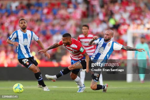 Luis Suarez of Granada CF is challenged by Aleix Vidal of Espanyol during the LaLiga Santander match between Granada CF and RCD Espanyol at Nuevo...