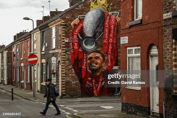 Woman walks past a mural of Jordan Henderso prior to the Premier League match between Liverpool and Wolverhampton Wanderers at Anfield on May 22,...