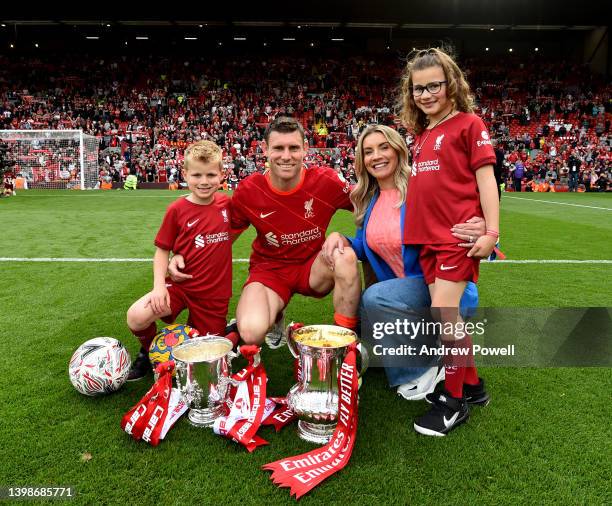 James Milner of Liverpool and his family posing with the Emirates FA Cup and the Carabao Cup at the end of the Premier League match between Liverpool...