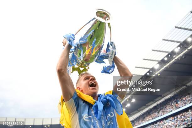 Oleksandr Zinchenko of Manchester City celebrates with the Premier League trophy and a Ukrainian flag after their side finished the season as Premier...