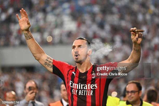 Zlatan Ibrahimovic of AC Milan celebrates with a cigar after their side finished the season as Serie A champions during the Serie A match between US...