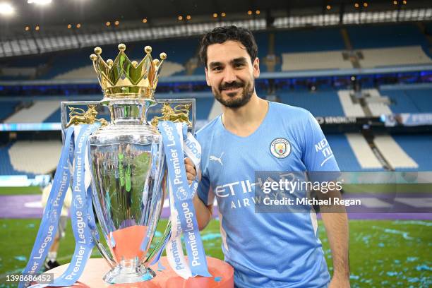 Ilkay Guendogan of Manchester City celebrates with the Premier League trophy after their side finished the season as Premier League champions during...