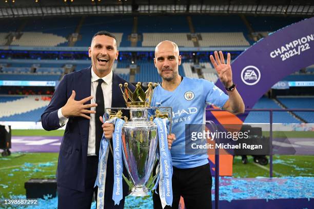 Khaldoon Al Mubarak, Chairperson of Manchester City and Pep Guardiola, Manager of Manchester City celebrate with the Premier League trophy after...