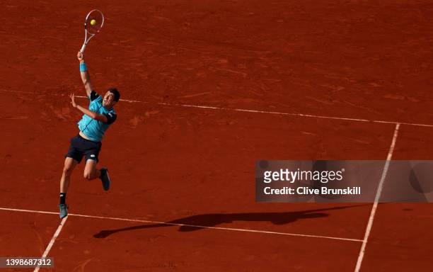 Sebastian Ofner of Austria plays a smash against Alexander Zverev of Germany in their mens singles first round match during the 2022 French Open at...
