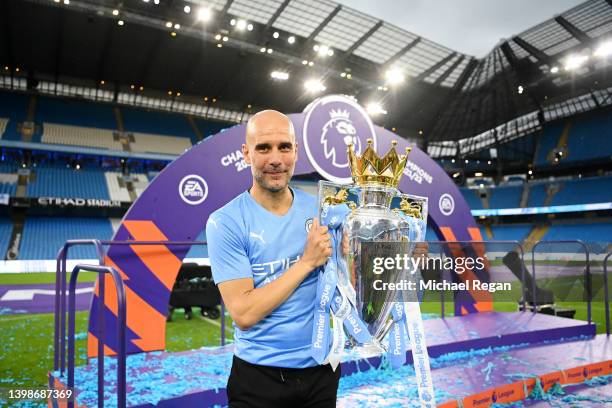 Pep Guardiola, Manager of Manchester City celebrates with the Premier League trophy after their side finished the season as Premier League champions...