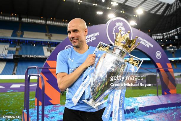 Pep Guardiola, Manager of Manchester City celebrates with the Premier League trophy after their side finished the season as Premier League champions...