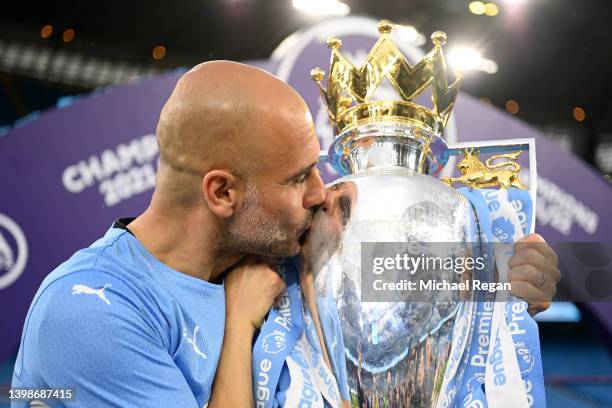 Pep Guardiola, Manager of Manchester City celebrates with the Premier League trophy after their side finished the season as Premier League champions...