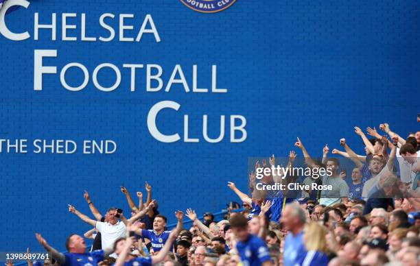 Chelsea supporters react positively to the news from other matches being played during the Premier League match between Chelsea and Watford at...