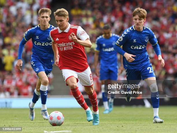 Martin Odegaard of Arsenal takes on Anthony Gordon of Everton during the Premier League match between Arsenal and Everton at Emirates Stadium on May...