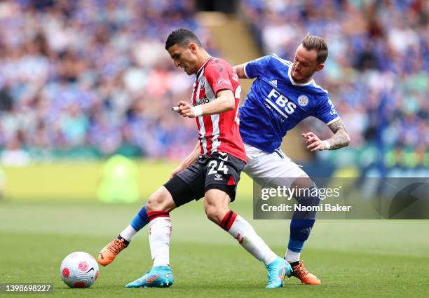 James Maddison of Leicester City challenges Mohamed Elyounoussi of Southampton during the Premier League match between Leicester City and Southampton...