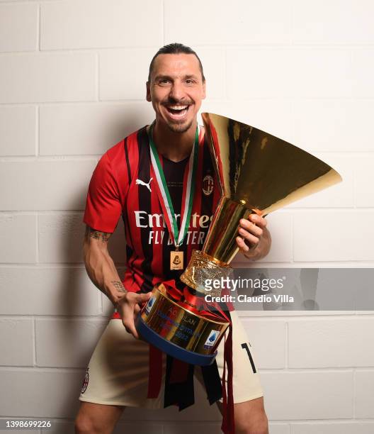 Zlatan Ibrahimovic of AC Milan poses with the trophy for the victory of "Scudetto " at the end of the last Serie A match between US Sassuolo and AC...