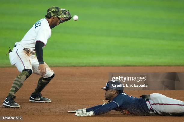 Ozzie Albies of the Atlanta Braves slides into second base after hitting a double in the ninth inning against the Miami Marlins at loanDepot park on...