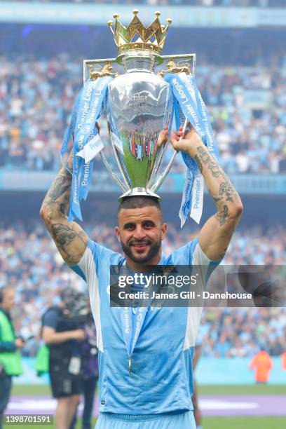 Kyle Walker of Manchester City celebrates with the Premier League trophy following the Premier League match between Manchester City and Aston Villa...