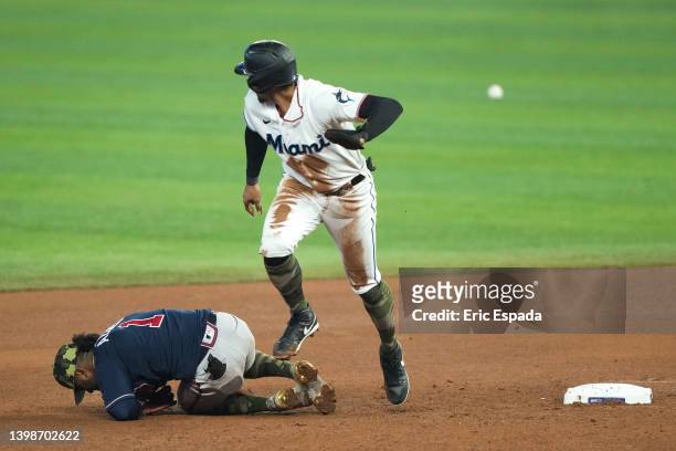 Erik Gonzalez of the Miami Marlins runs towards third base after an overthrow on a steal attempt in the seventh inning against the Atlanta Braves at...