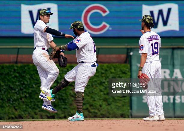 Seiya Suzuki, Jonathan Villar and Andrelton Simmons of the Chicago Cubs celebrate their team win over the Arizona Diamondbacks at Wrigley Field on...