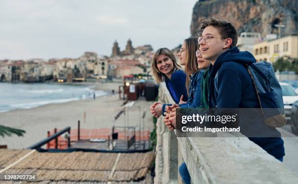 family sightseeing beautiful italian town of cefalu in sicily - family city break stock pictures, royalty-free photos & images