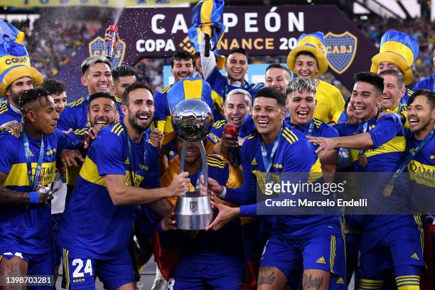 Carlos Izquierdoz and Marcos Rojo of Boca Juniors a teammates lift the trophy as they become champions of the Copa de la Liga 2022 after winning the...