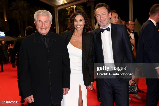 Claude Lelouch, Nadia Farès and a guest attend the screening of "November " during the 75th annual Cannes film festival at Palais des Festivals on...