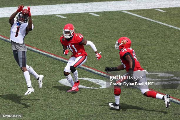 Isaiah Zuber of the Houston Gamblers jumps to catch the ball as De'Vante Bausby and Angelo Garbutt of the New Jersey Generals defends in the first...