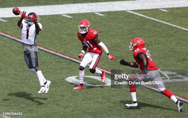 Isaiah Zuber of the Houston Gamblers jumps to catch the ball as De'Vante Bausby and Angelo Garbutt of the New Jersey Generals defends in the first...
