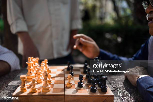 senior men playing chess - game night stock pictures, royalty-free photos & images