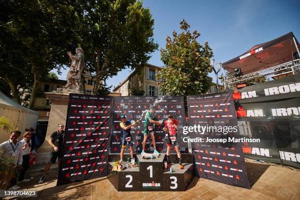 Florent Rabany and Julien Hoeksema of France and Romain Aymon of Switzerland reacts in the IRONMAN Aix en Provence medal ceremony on May 22, 2022 in...