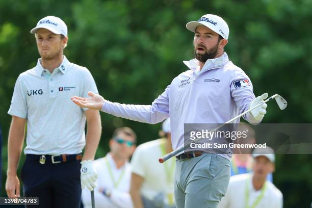 Cameron Young of the United States reacts to his shot on the 14th tee as Will Zalatoris of the United States looks onduring the final round of the...