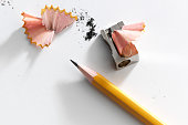 Close-up of a pencil and a sharpener with pencil shavings