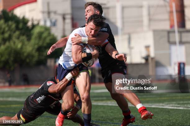 Andrew Coe of Rugby New York is tackled by Ryan Rees of Rugby ATL in the second half of the Major League Rugby match at JFK Stadium on May 22, 2022...